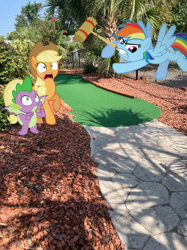 Size: 1280x1707 | Tagged: safe, edit, editor:undeadponysoldier, imported from ponybooru, photographer:undeadponysoldier, applejack, rainbow dash, spike, dragon, earth pony, pegasus, pony, angry, best friends, croquet mallet, dragons in real life, edited photo, female, flying, frustrated, hanging out, irl, male, mare, minigolf, outdoors, photo, ponies in real life, rage, raised hoof, raised leg, scared, summer, this will not end well, vacation, winged spike