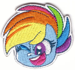 Size: 1050x984 | Tagged: safe, imported from derpibooru, rainbow dash, pegasus, my little pony: pony life, 2d, chibi, looking at you, merchandise, official, one eye closed, patch, photo, wink, winking at you