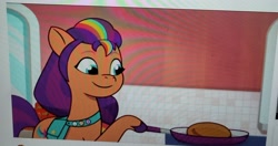 Size: 3000x1589 | Tagged: safe, imported from derpibooru, screencap, sunny starscout, spoiler:g5, bag, crystal brighthouse, cute, cutie mark, food, g5, mane stripe sunny, my little pony: tell your tale, pancakes, photo, picture of a screen, saddle bag, sunnybetes
