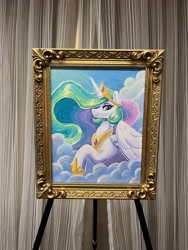 Size: 1536x2048 | Tagged: safe, artist:dandy, imported from derpibooru, princess celestia, alicorn, pony, acrylic painting, cloud, crown, eyeshadow, female, framed picture, hair over one eye, horn, jewelry, looking at you, makeup, mare, mare fair, mare gallery, painting, photo, raised hoof, regalia, sky, smiling, traditional art, wings