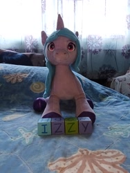 Size: 2448x3264 | Tagged: safe, imported from derpibooru, izzy moonbow, original species, plush pony, unicorn, alphabet, building blocks, cute, female, g5, horn, izzybetes, mare, my little pony: make your mark, my little pony: make your mark chapter 4, my little pony: tell your tale, name, plushie