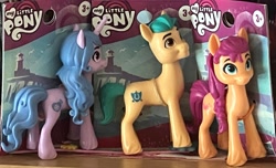 Size: 3711x2263 | Tagged: safe, imported from derpibooru, hitch trailblazer, izzy moonbow, sunny starscout, g5, irl, merchandise, minifig, my little pony logo, photo, toy, trio, unshorn fetlocks