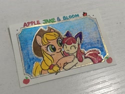 Size: 4000x3000 | Tagged: safe, artist:foluolunsadedengta, imported from derpibooru, apple bloom, applejack, earth pony, pony, apple, apple sisters, bow, eyes closed, female, filly, foal, food, hair bow, hat, hug, mare, passepartout, photo, siblings, sisters, sky background, smiling, stamp, text, traditional art