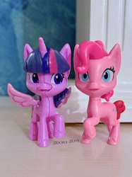 Size: 3058x4078 | Tagged: safe, imported from derpibooru, pinkie pie, twilight sparkle, alicorn, my little pony: pony life, cracking, figure, front view, irl, kinder egg, looking at someone, merchandise, official, open mouth, photo, raised hoof, spread wings, toy, twilight sparkle (alicorn), wings