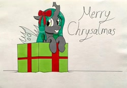 Size: 3500x2445 | Tagged: safe, artist:killerteddybear94, imported from derpibooru, queen chrysalis, changeling, changeling queen, pony, bow, box, christmas, cute, cutealis, female, hair bow, holiday, looking at you, pony in a box, present, pun, traditional art