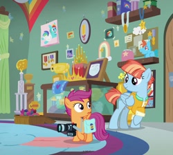 Size: 804x720 | Tagged: safe, edit, edited screencap, imported from derpibooru, screencap, rainbow dash, scootaloo, windy whistles, pegasus, pony, parental glideance, bag, camera, clothes, cropped, female, filly, foal, freckles, jacket, looking at each other, looking at someone, mare, saddle bag, smiling, trophy, trophy room