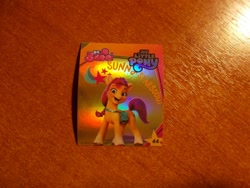 Size: 1024x768 | Tagged: safe, imported from derpibooru, sunny starscout, earth pony, 3d, cutie mark, g5, indonesian, logo, looking at you, merchandise, my little pony: a new generation, official, photo, shiny, standing, stars, sticker