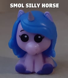 Size: 1203x1374 | Tagged: safe, imported from derpibooru, izzy moonbow, pony, unicorn, caption, g5, horn, irl, merchandise, pencil topper, photo, text, toy