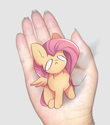 Size: 1997x2280 | Tagged: safe, artist:miryelis, imported from derpibooru, fluttershy, human, pegasus, pony, crying, cute, disembodied hand, full body, hand, in goliath's palm, irl, irl human, meme, micro, photo, sitting, size difference, small pony, smol, solo