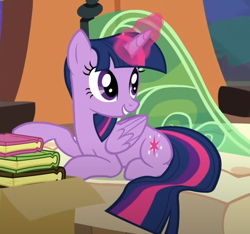 Size: 628x589 | Tagged: safe, imported from derpibooru, screencap, twilight sparkle, alicorn, pony, book, box, cropped, folded wings, friendship express, glowing, glowing horn, horn, locomotive, lying down, prone, smiling, solo, steam locomotive, trade ya!, train, twilight sparkle (alicorn), wings
