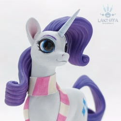 Size: 2560x2560 | Tagged: safe, alternate angle, alternate version, artist:lakterra, imported from derpibooru, rarity, pony, unicorn, close-up, clothes, craft, female, figurine, horn, irl, mare, photo, polymer clay, scarf, signature, simple background, smiling, solo, striped scarf, tail, white background
