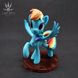 Size: 2560x2560 | Tagged: safe, alternate angle, alternate version, artist:lakterra, imported from derpibooru, rainbow dash, pegasus, pony, craft, female, figurine, irl, looking up, mare, photo, polymer clay, raised hoof, signature, smiling, solo, spread wings, stand, tail, wings