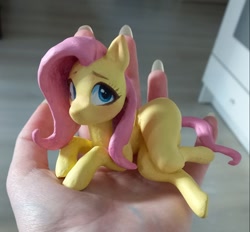 Size: 1125x1044 | Tagged: safe, artist:emysdraw, imported from derpibooru, fluttershy, pegasus, pony, craft, female, hand, holding a pony, irl, lying down, mare, on side, photo, sculpture, solo