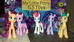 Size: 960x540 | Tagged: safe, imported from derpibooru, hitch trailblazer, izzy moonbow, pipp petals, sunny starscout, zipp storm, earth pony, pegasus, pony, unicorn, brush, brushable, dollar general, g5, horn, logo, mane five, merchandise, photo, price tag, text, toy