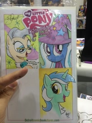 Size: 768x1024 | Tagged: safe, artist:andy price, artist:thom zahler, artist:tonyfleecs, imported from derpibooru, lyra heartstrings, mayor mare, trixie, earth pony, pony, unicorn, c2e2, c2e2 2014, clothes, collaboration, female, glasses, hat, horn, irl, mare, my little pony logo, photo, sparkles, traditional art, trixie's hat