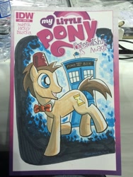 Size: 768x1024 | Tagged: safe, artist:thom zahler, idw, imported from derpibooru, doctor whooves, time turner, pony, spoiler:comic13, 2014, bowtie, comic cover, commission, cover, cover art, doctor who, fez, grin, hat, irl, male, my little pony logo, new york comic con, new york comic con 2014, photo, raised hoof, smiling, solo, stallion, tail, tardis, traditional art