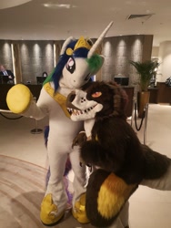 Size: 2976x3968 | Tagged: safe, artist:atalonthedeer, artist:tapewolf, imported from derpibooru, princess celestia, dinosaur, duo, furry, fursuit, indoors, irl, jewelry, photo, ponysuit, regalia