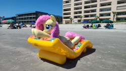 Size: 4032x2268 | Tagged: safe, artist:anonymous, imported from derpibooru, fluttershy, human, pegasus, pony, blushing, female, fluttershy plushie, inflatable, inflatable lounge, irl, irl human, life size, mare, outdoors, photo, plushie, relaxing