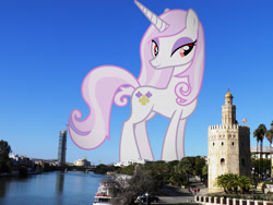 Size: 2048x1536 | Tagged: safe, artist:90sigma, edit, editor:jaredking779, imported from derpibooru, fleur-de-lis, pony, unicorn, alternate eye color, attack on pony, concave belly, eyeshadow, female, giant pony, giantess, highrise ponies, horn, irl, lidded eyes, looking at you, macro, makeup, mare, photo, ponies in real life, seville, smiling, solo, spain, standing, story included, wrong eye color