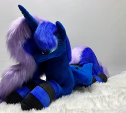 Size: 1280x1150 | Tagged: safe, artist:melodis, imported from derpibooru, princess luna, alicorn, pony, clothes, folded wings, irl, lying down, photo, plushie, prone, socks, solo, striped socks, wings