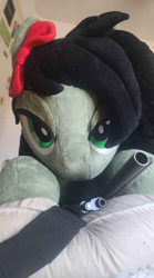 Size: 488x877 | Tagged: safe, imported from twibooru, photographer:redcrow32, oc, oc only, oc:filly anon, pony, bed, bow, female, filly, gun, hair bow, handgun, image, lidded eyes, life size, looking at you, photo, pistol, plushie, png, solo, weapon