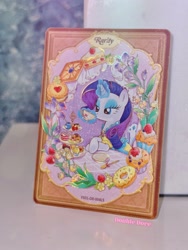 Size: 2206x2941 | Tagged: safe, imported from derpibooru, rarity, pony, unicorn, afternoon tea, cake, card, clothes, cup, dessert, double dove, dress, flower, food, horn, irl, kayou, looking down, magic, magic aura, merchandise, official, outfit, photo, plate, solo, teacup, text