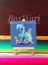 Size: 1200x1599 | Tagged: safe, artist:boxwari, imported from derpibooru, trixie, pony, unicorn, acrylic painting, easel, female, flower, flower in hair, horn, looking at you, mare, photo, pointy ponies, smiling, smiling at you, solo, traditional art, watermark