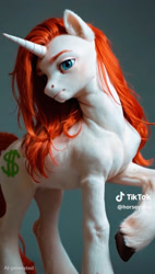 Size: 1284x2255 | Tagged: safe, ai generated, artist:horseyslop, screencap, oc, oc:lmoney, pony, unicorn, 2025, blue eyes, cropped, g4, gray background, kling ai, long hair, long mane, long tail, muscles, raised hoof, red mane, simple background, solo, tall, tiktok, watermark, white coat